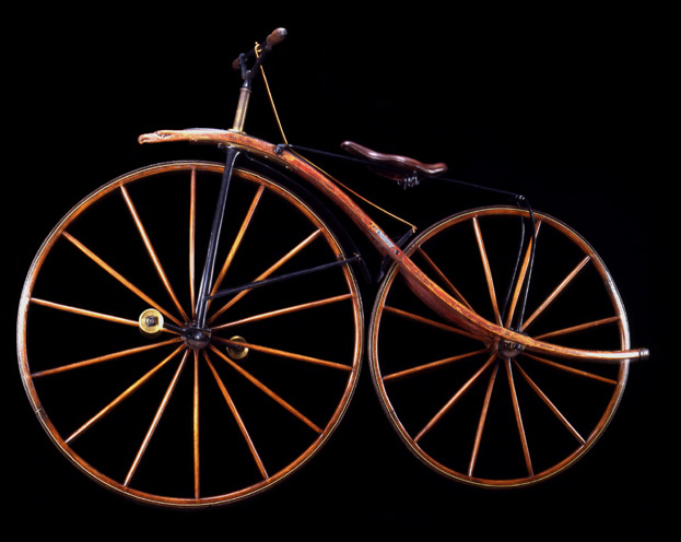Velocipede, ca. 1870<br>
George C. Miller, Chicago<br>
United States<p>
	
The ornate front extension with the
carved eagle's head and the wood frame
that sweeps beyond the rear wheel are
unique embellishments.